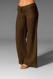Wide leg linen trousers with drawstring waist, featuring a relaxed fit for women, perfect for casual outings in natural linen fabric. 4