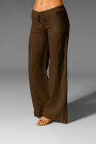Wide leg linen trousers with drawstring waist, featuring a relaxed fit for women, perfect for casual outings in natural linen fabric. 4