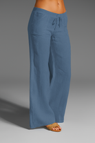 Wide leg linen trousers with drawstring waist, featuring a relaxed fit for women, perfect for casual outings in natural linen fabric. 5