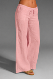 Wide leg linen trousers with drawstring waist, featuring a relaxed fit for women, perfect for casual outings in natural linen fabric. 7