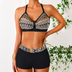Women's bikini set featuring a stylish V-neck halter top and comfortable swim shorts, made from lightweight polyester and spandex, perfect for beachwear and summer 2