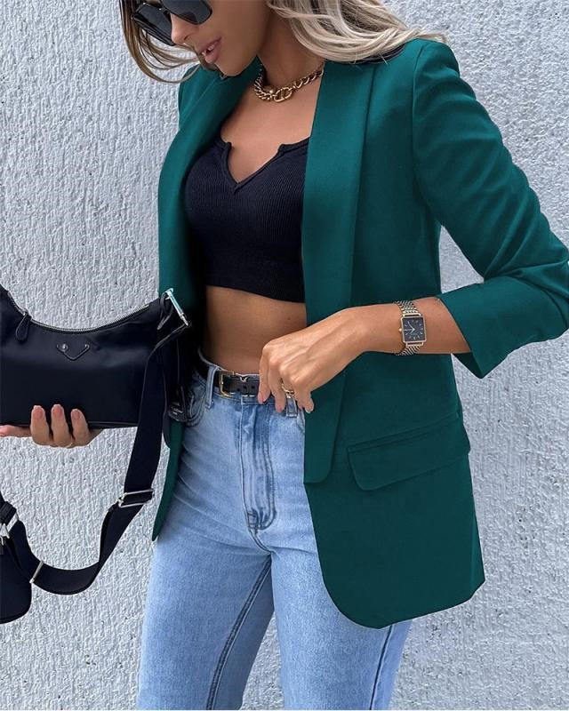 Women's fitted blazer with shawl collar and flap pockets, ideal for smart casual wear, featuring an open front design and tailored waist for a flattering silhouette. 1