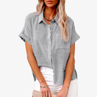 Lightweight white short sleeve women's blouse featuring a button-up front and classic collar, perfect for summer wear. 0