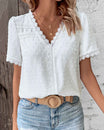Women's white Swiss dot blouse featuring decorative trim, a stylish V-neck design, and short sleeves, perfect for summer wear. 0