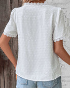 Women's white Swiss dot blouse featuring decorative trim, a stylish V-neck design, and short sleeves, perfect for summer wear. 3