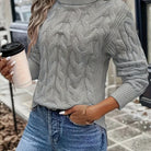 Women's cable-knit turtleneck sweater featuring a relaxed fit, perfect for cozy warmth during autumn and winter seasons. 12