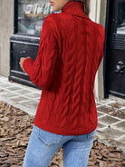 Women's cable-knit turtleneck sweater featuring a relaxed fit, perfect for cozy warmth during autumn and winter seasons. 2