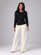Women's cable knit sweater featuring button shoulder detail, crew neck design, and a stylish diamond knit pattern in a cozy and fashionable look. 3