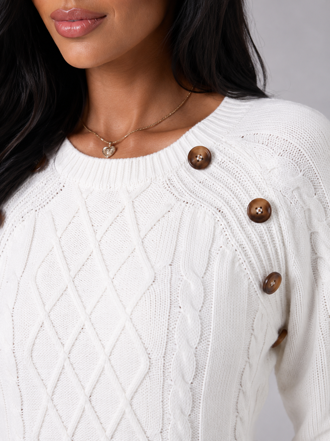 Women's cable knit sweater featuring button shoulder detail, crew neck design, and a stylish diamond knit pattern in a cozy and fashionable look. 6
