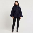 Women's oversized winter coat featuring a high collar and adjustable belt, designed for warmth and style, perfect for cold weather fashion. 2