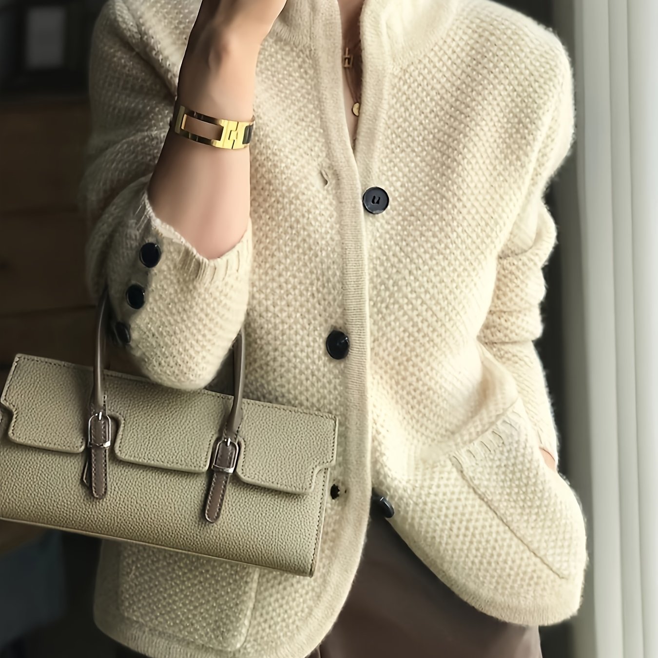 Women's cardigan featuring a structured stand collar and statement buttons, crafted from textured honeycomb knit in a stylish apricot and brown color palette. 0