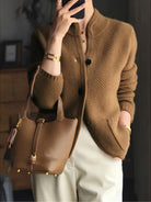Women's cardigan featuring a structured stand collar and statement buttons, crafted from textured honeycomb knit in a stylish apricot and brown color palette. 2