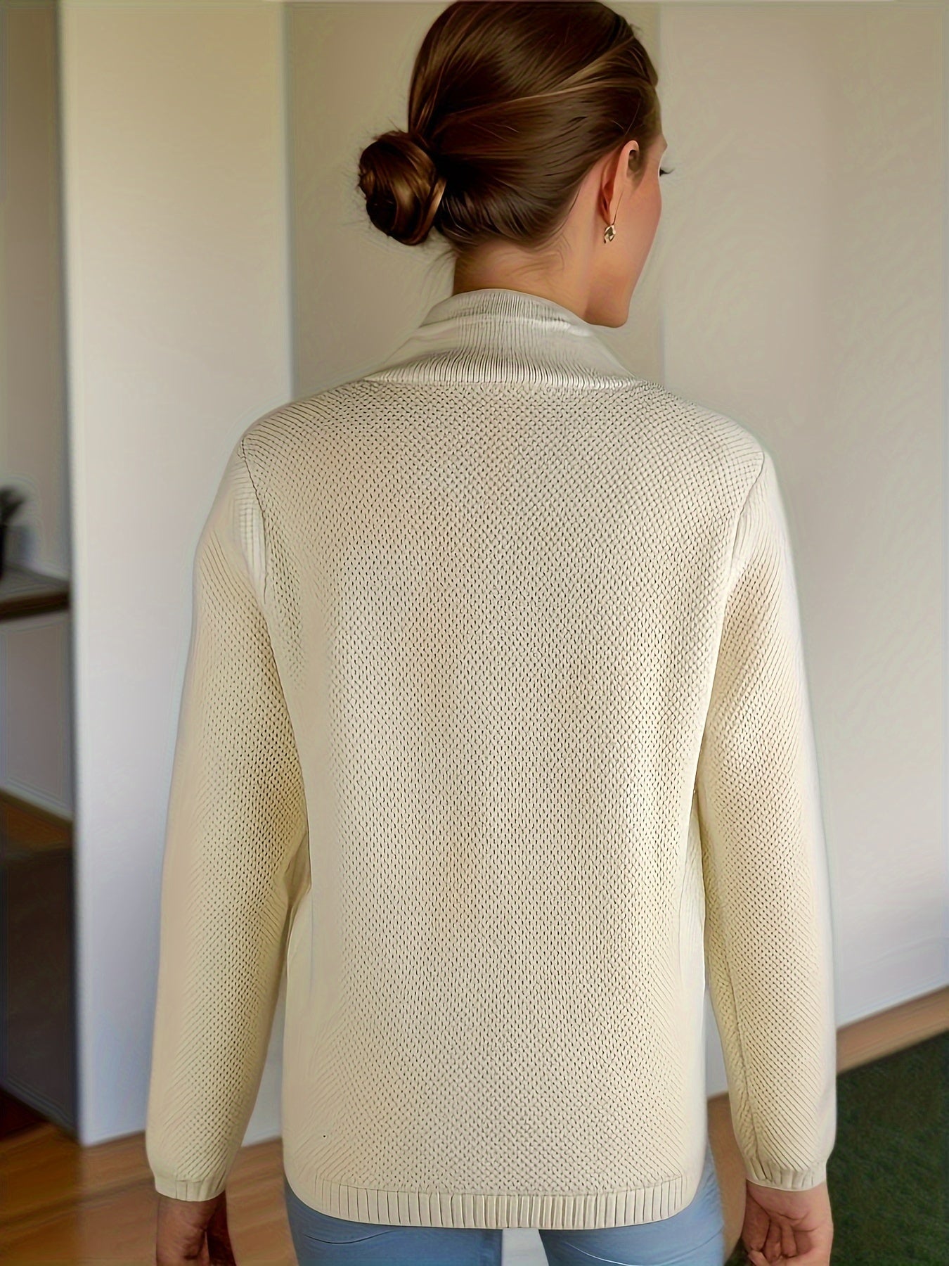 Women's cardigan featuring a structured stand collar and statement buttons, crafted from textured honeycomb knit in a stylish apricot and brown color palette. 4