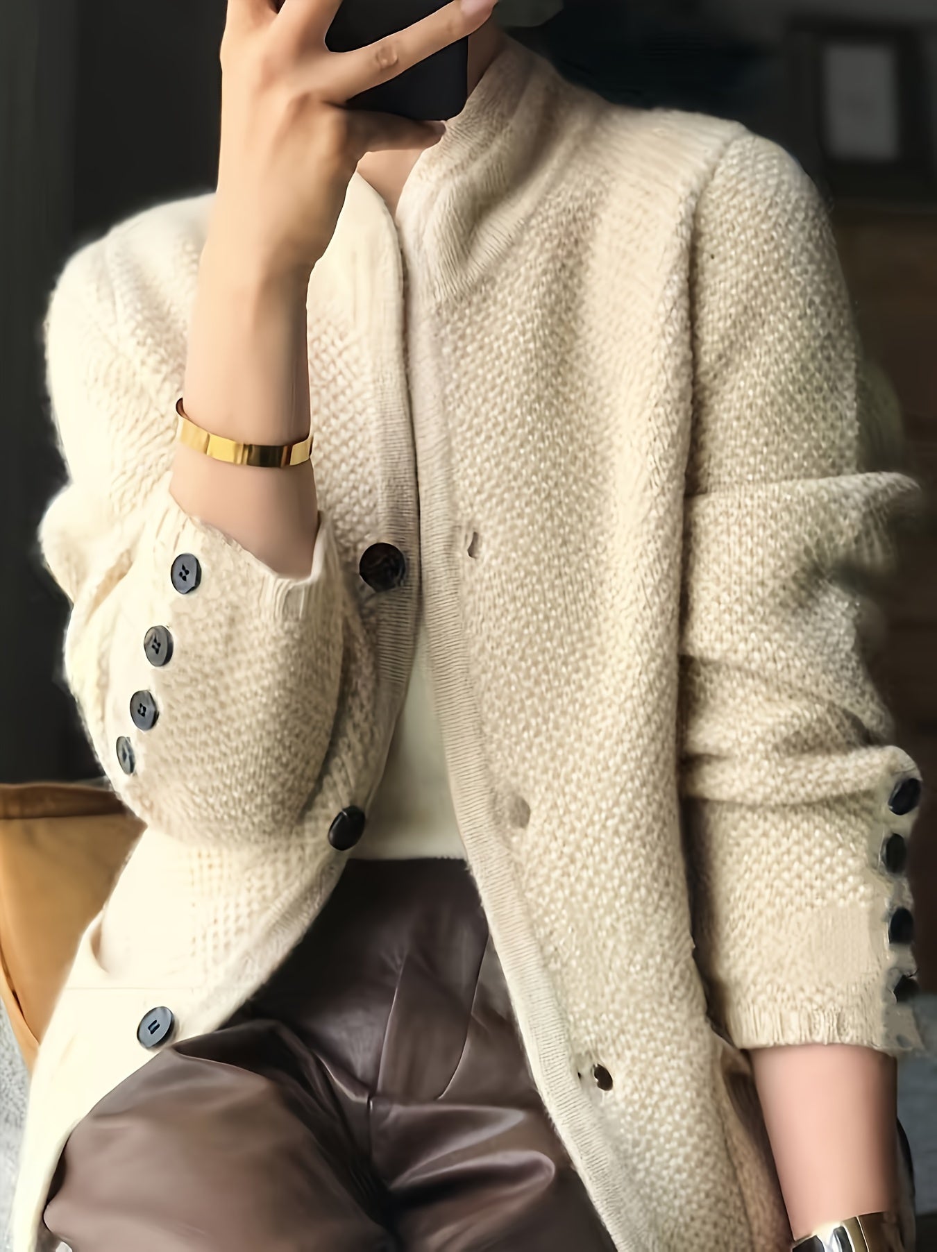 Women's cardigan featuring a structured stand collar and statement buttons, crafted from textured honeycomb knit in a stylish apricot and brown color palette. 6