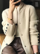 Women's cardigan featuring a structured stand collar and statement buttons, crafted from textured honeycomb knit in a stylish apricot and brown color palette. 6