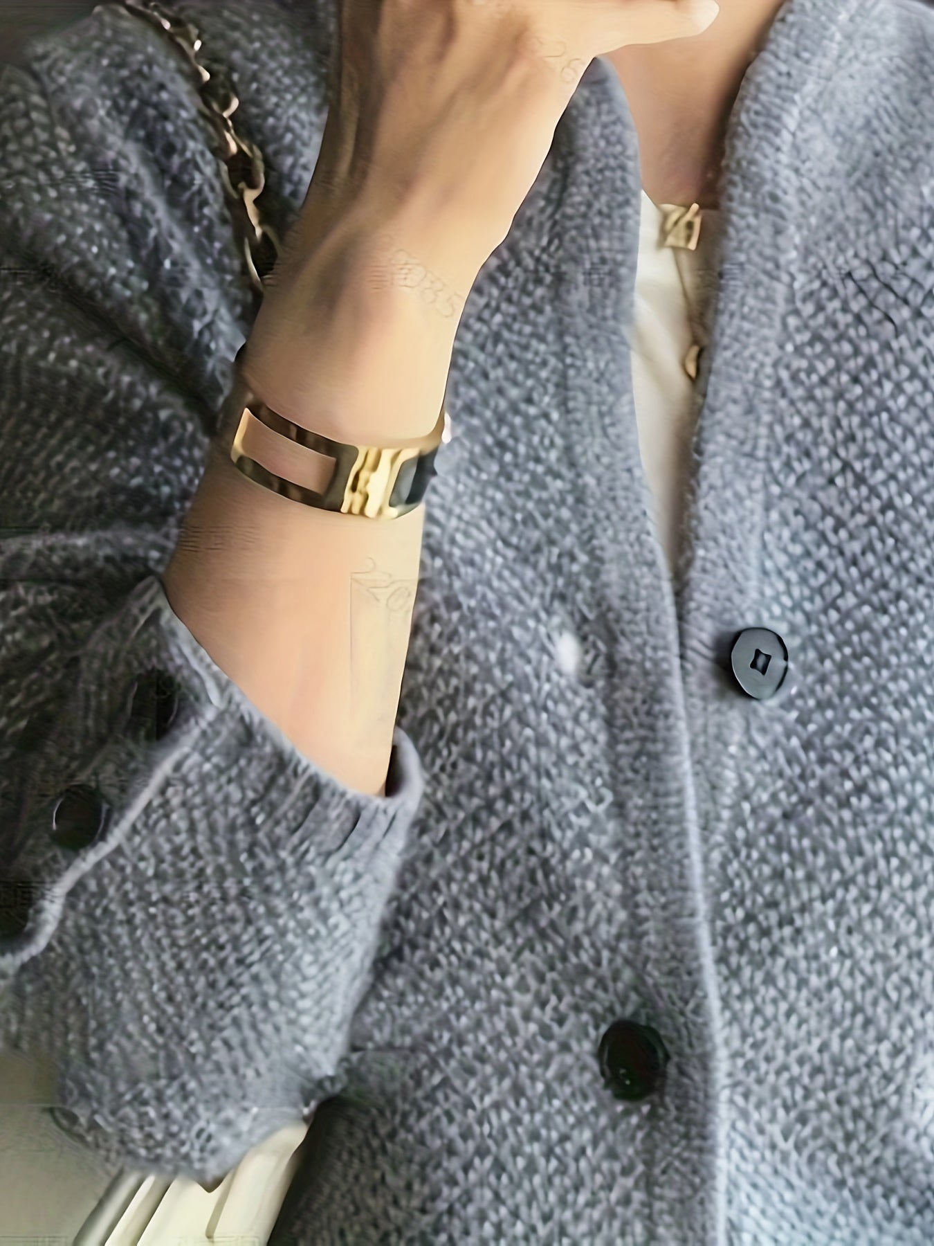Women's cardigan featuring a structured stand collar and statement buttons, crafted from textured honeycomb knit in a stylish apricot and brown color palette. 7