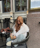 Women's oversized faux fur coat providing luxurious winter warmth with a stylish hip-length design. 1