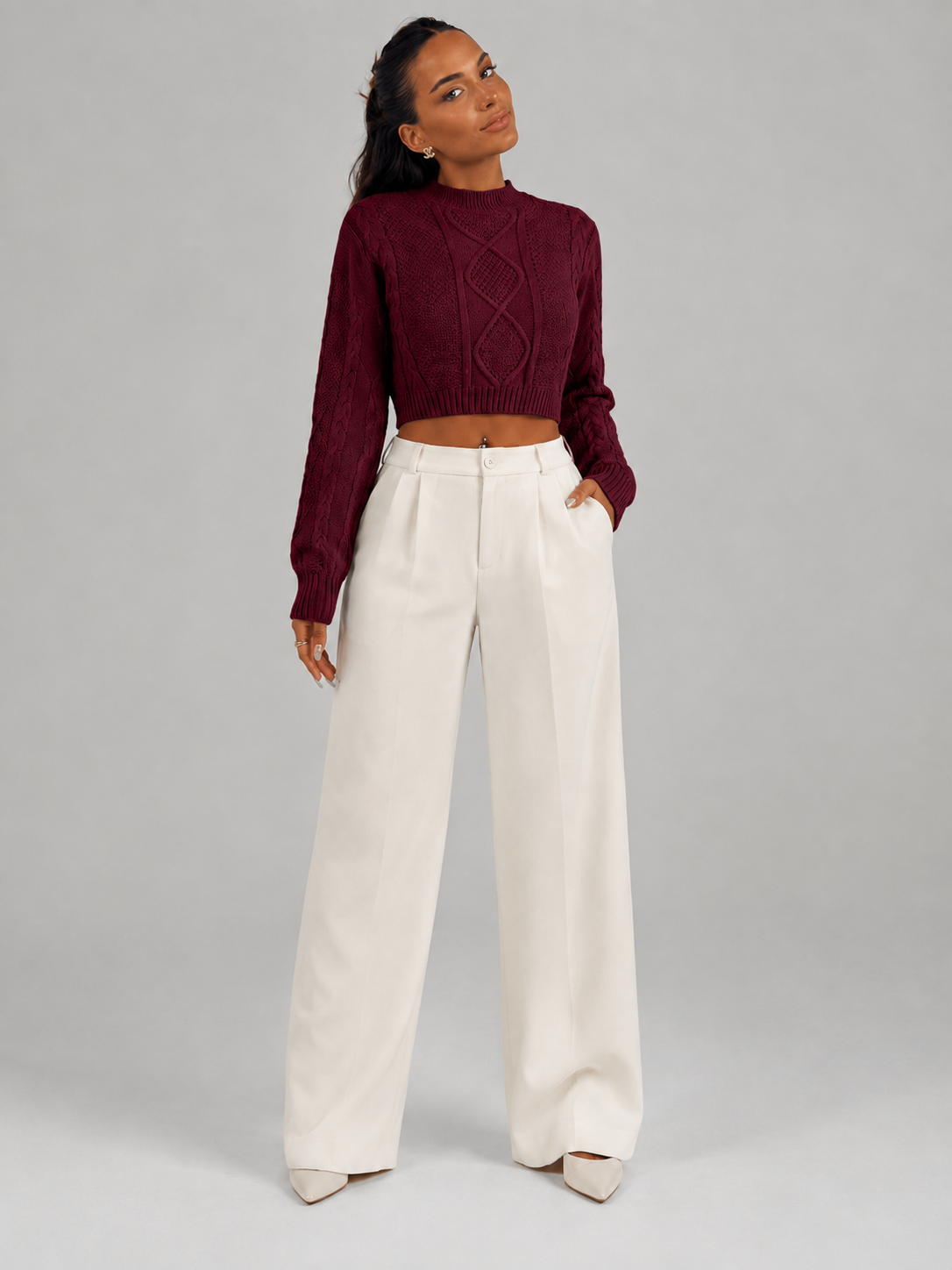 Women's cropped cable knit jumper featuring a mock neck and blouson sleeves, designed with a chunky knit for a cozy and stylish look. 3
