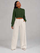 Women's cropped cable knit jumper featuring a mock neck and blouson sleeves, designed with a chunky knit for a cozy and stylish look. 4