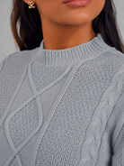 Women's cropped cable knit jumper featuring a mock neck and blouson sleeves, designed with a chunky knit for a cozy and stylish look. 6