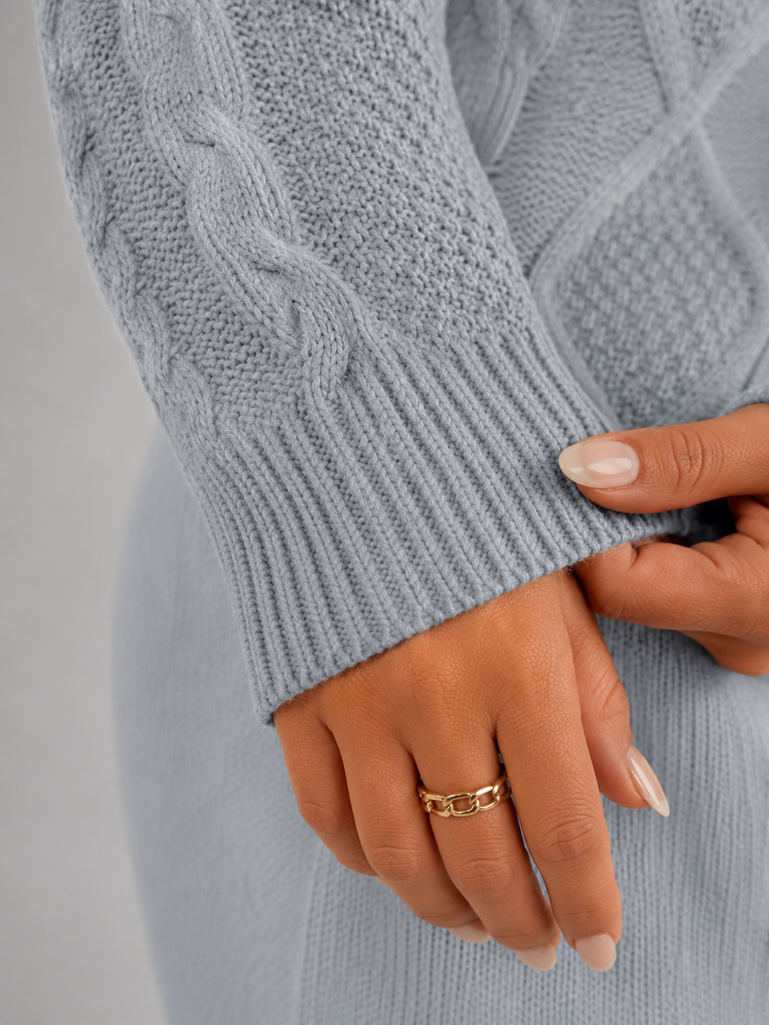 Women's cropped cable knit jumper featuring a mock neck and blouson sleeves, designed with a chunky knit for a cozy and stylish look. 7