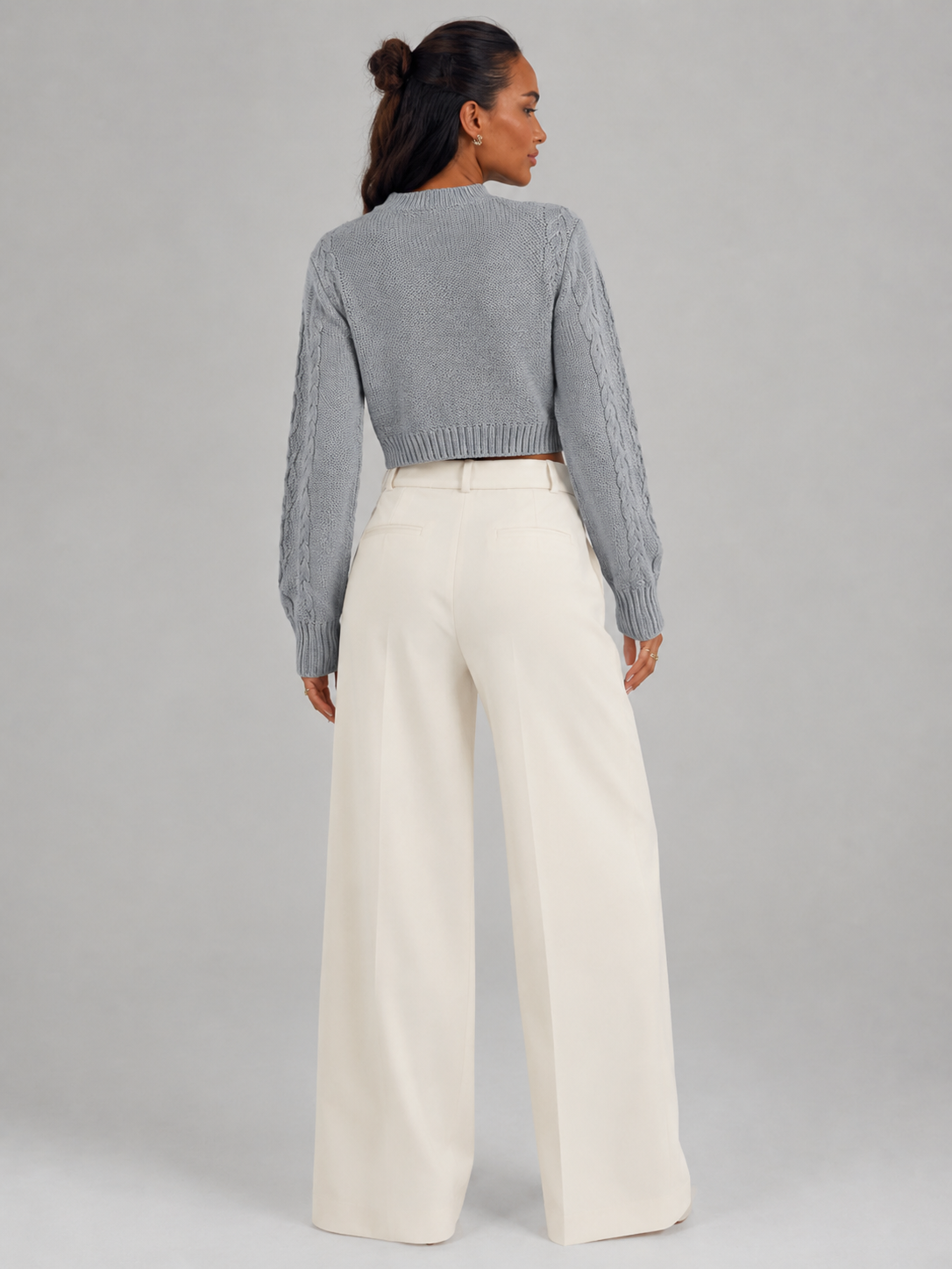 Women's cropped cable knit jumper featuring a mock neck and blouson sleeves, designed with a chunky knit for a cozy and stylish look. 8