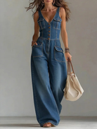 Women's denim jumpsuit featuring a V-neckline and wide-leg pants, elegantly designed in classic blue with a stylish sleeveless cut. 0