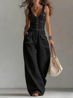 Women's denim jumpsuit featuring a V-neckline and wide-leg pants, elegantly designed in classic blue with a stylish sleeveless cut. 2