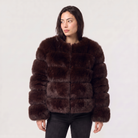 Women's faux fur jacket featuring a concealed fastening, designed for a relaxed fit and hip-length styling, perfect for fashionable layering in cool weather. 10
