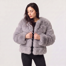 Women's faux fur jacket featuring a concealed fastening, designed for a relaxed fit and hip-length styling, perfect for fashionable layering in cool weather. 7