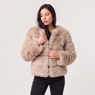 Women's faux fur jacket featuring a concealed fastening, designed for a relaxed fit and hip-length styling, perfect for fashionable layering in cool weather. 9