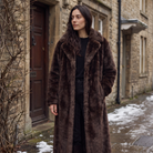 Women's faux fur trench coat featuring double-button fastening, side pockets, and a long relaxed fit, perfect for stylish winter outerwear. 1