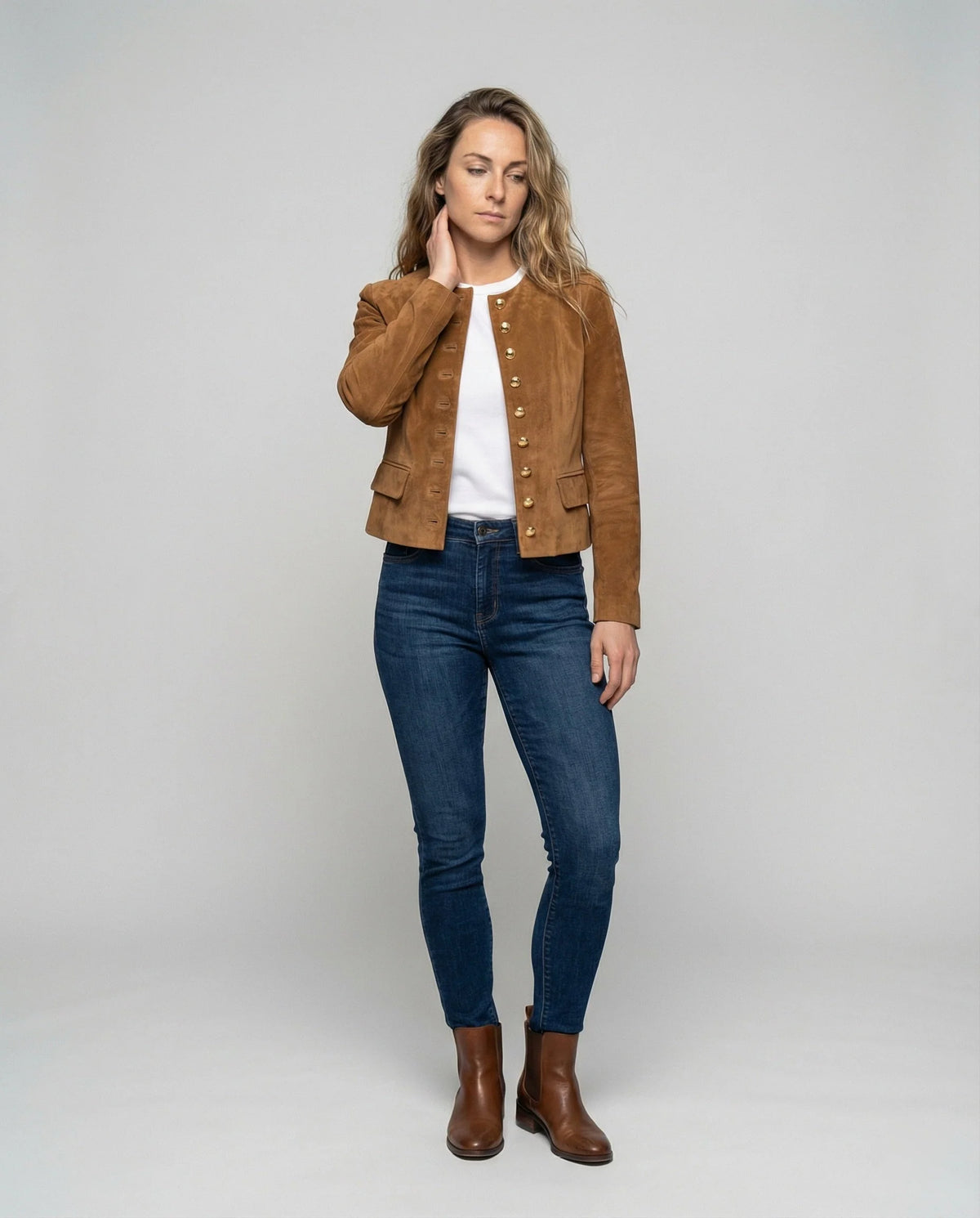 Women's faux suede jacket featuring an elegant fitted collarless design and stylish gold buttons, perfect for a smart casual look. 1