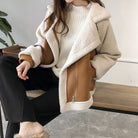 Women's oversized aviator winter coat in beige and brown featuring plush fleece lining and an asymmetric zip design, perfect for stylish warmth in colder months. 2