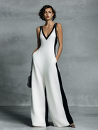 Women's black and white patchwork cotton linen jumpsuit featuring a wide-leg fit and deep V-neck design, perfect for casual or chic occasions. 1