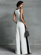 Women's black and white patchwork cotton linen jumpsuit featuring a wide-leg fit and deep V-neck design, perfect for casual or chic occasions. 4