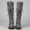 Women's black faux leather knee-high boots featuring a lace-up front, block heel, and stylish stud detail. 2