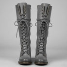Women's black faux leather knee-high boots featuring a lace-up front, block heel, and stylish stud detail. 2