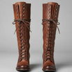 Women's black faux leather knee-high boots featuring a lace-up front, block heel, and stylish stud detail. 4