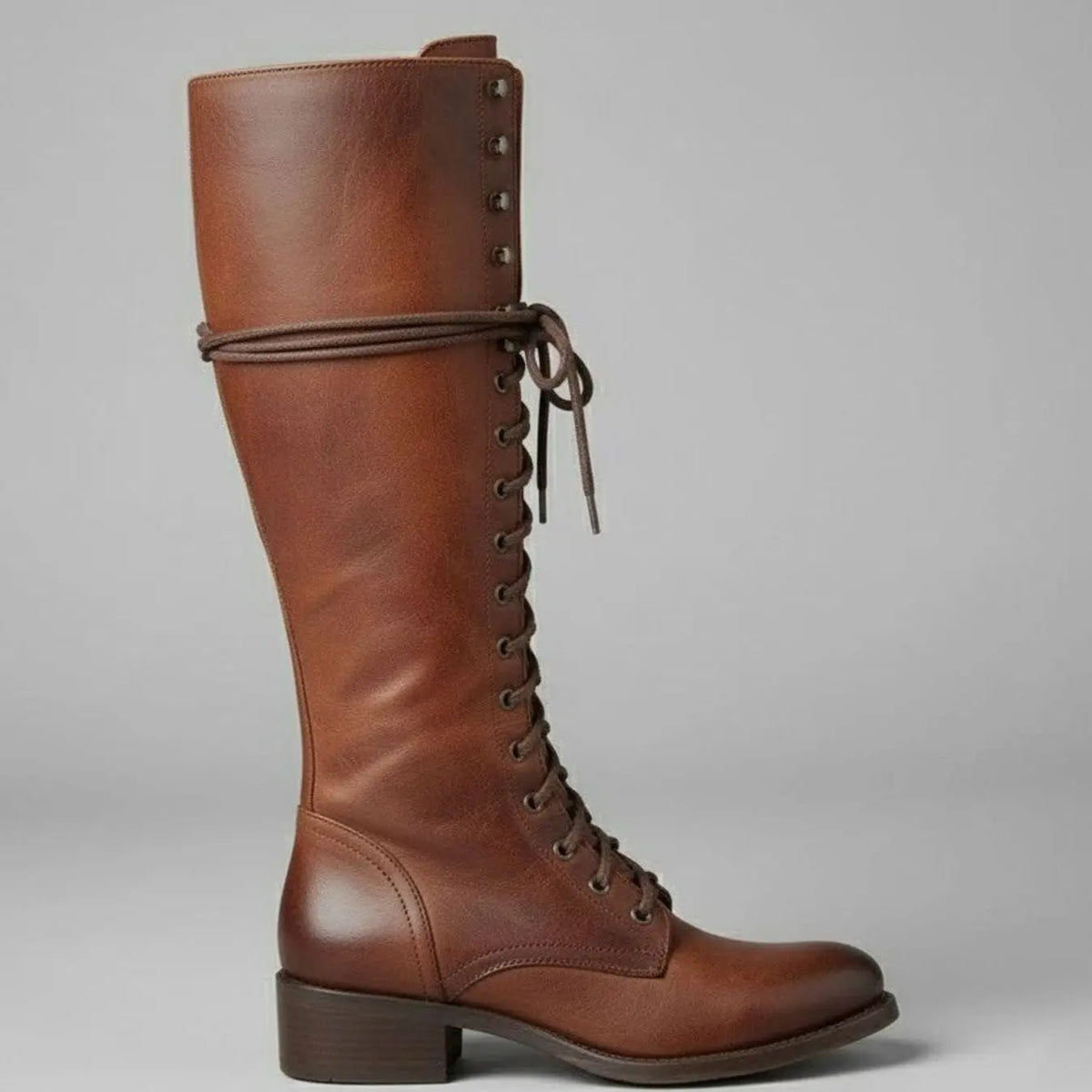 Women's black faux leather knee-high boots featuring a lace-up front, block heel, and stylish stud detail. 5