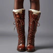 Women's black faux leather knee-high boots featuring a lace-up front, block heel, and stylish stud detail. 9