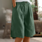 Women's linen blend shorts featuring an elastic waistband, designed for lightweight comfort and casual summer wear, complete with convenient pockets. 0