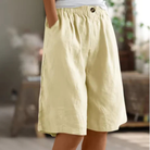 Women's linen blend shorts featuring an elastic waistband, designed for lightweight comfort and casual summer wear, complete with convenient pockets. 2