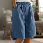 Women's linen blend shorts featuring an elastic waistband, designed for lightweight comfort and casual summer wear, complete with convenient pockets. 3