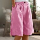 Women's linen blend shorts featuring an elastic waistband, designed for lightweight comfort and casual summer wear, complete with convenient pockets. 4