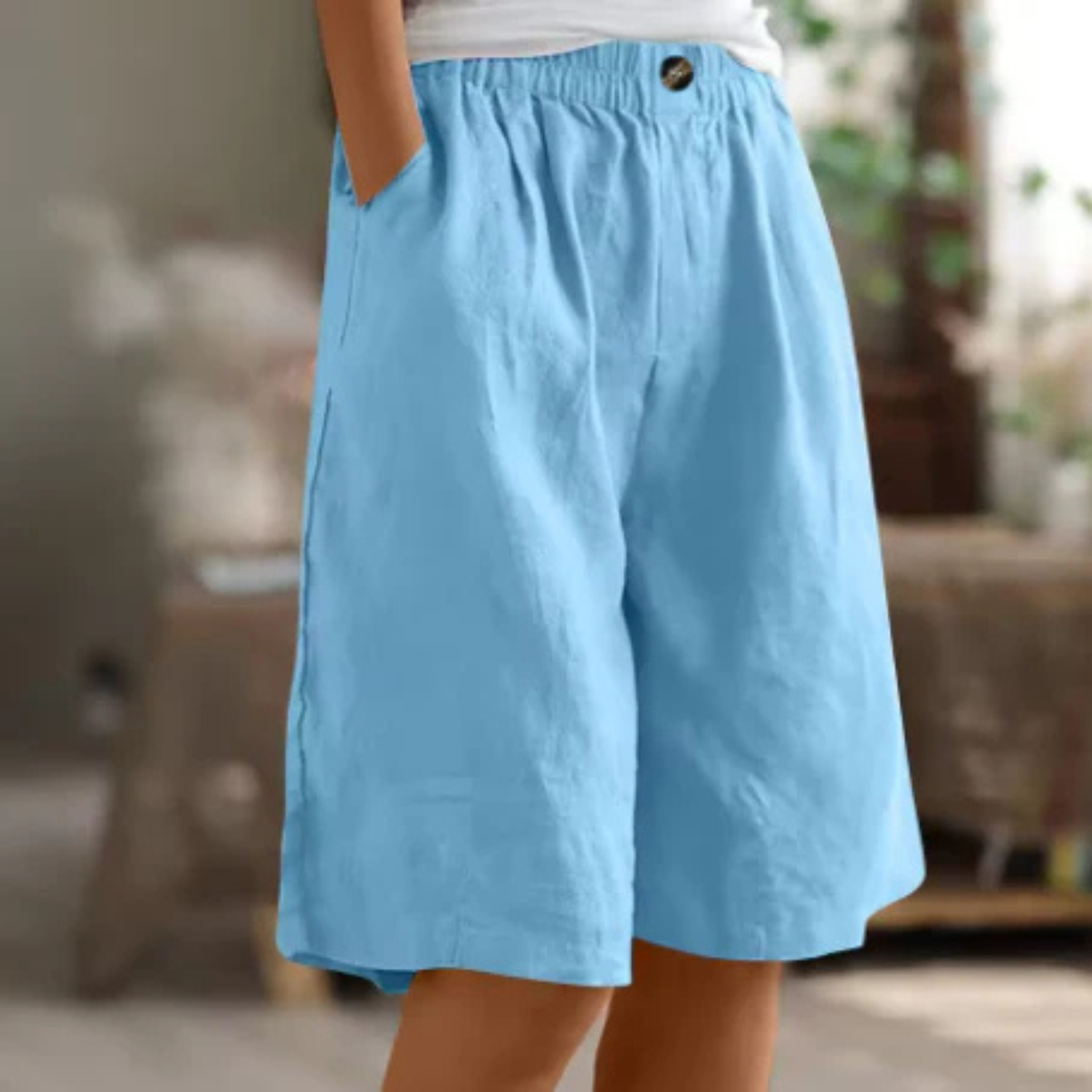 Women's linen blend shorts featuring an elastic waistband, designed for lightweight comfort and casual summer wear, complete with convenient pockets. 6