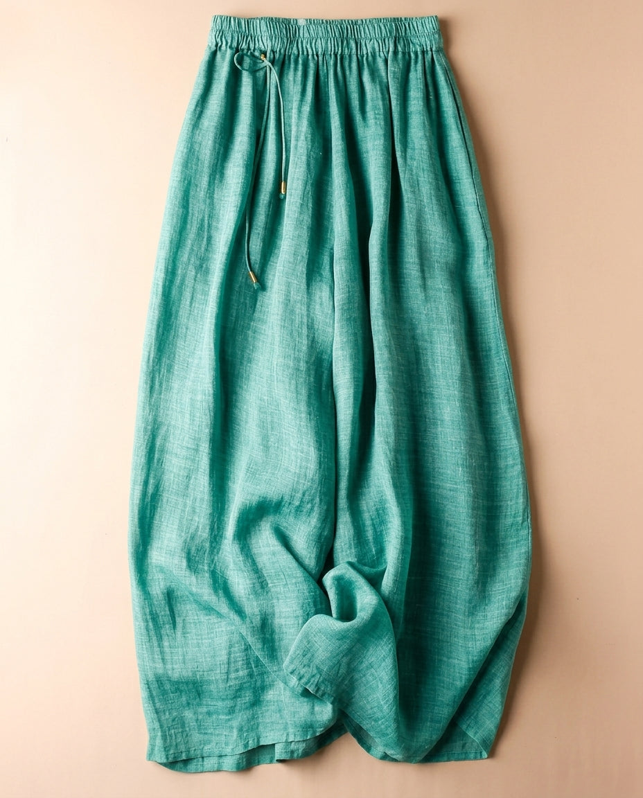 Women's linen pants featuring an elastic waistband and a relaxed wide leg design, perfect for comfortable casual wear. 0