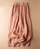Women's linen pants featuring an elastic waistband and a relaxed wide leg design, perfect for comfortable casual wear. 1