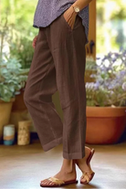 Women's linen pants with an elastic waistband, featuring a casual cropped summer style and breathable relaxed fit, perfect for warm weather outings. 2