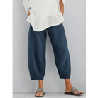 Women's lightweight casual white linen pants featuring an elastic waistband, perfect for summer leisure and comfort. 2